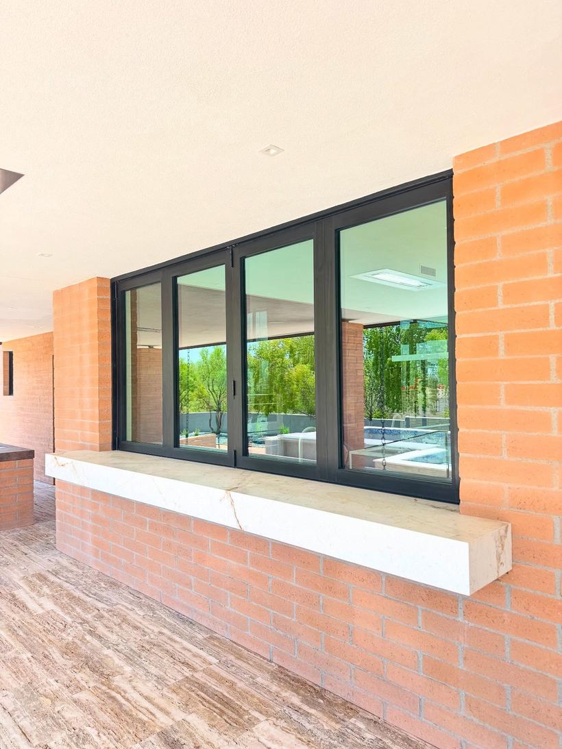 Black-framed windows with a marble sill