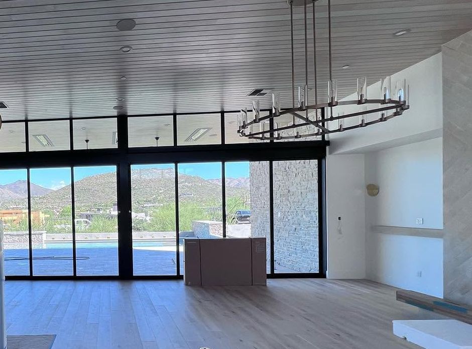 Large glass doors open to a mountain view