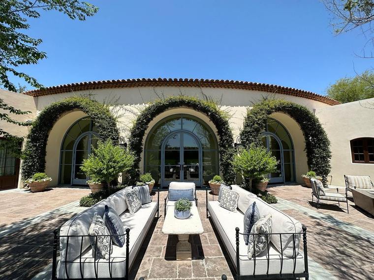 Arched windows and doors facing a landscaped courtyard